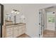 Bright bathroom featuring a vanity with granite countertop, framed mirror and access to an adjacent room at 104 Whiterock Dr, Mount Holly, NC 28120