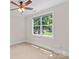 Bright bedroom with a large window providing natural light and views of the outdoors at 104 Whiterock Dr, Mount Holly, NC 28120
