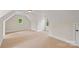 Versatile bonus room with vaulted ceilings, carpeted floor, and natural light from two windows at 104 Whiterock Dr, Mount Holly, NC 28120