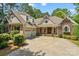 Charming home featuring stone accents, a welcoming front porch, well-manicured landscaping, and a spacious driveway at 104 Whiterock Dr, Mount Holly, NC 28120