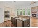 Well-appointed kitchen with island, breakfast bar, built-in appliances, and stone fireplace at 104 Whiterock Dr, Mount Holly, NC 28120
