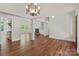 Open-concept living room with hardwood floors, fireplace, and plenty of natural light at 104 Whiterock Dr, Mount Holly, NC 28120