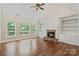 Bright living room with built-in shelving, fireplace, and views of the backyard at 104 Whiterock Dr, Mount Holly, NC 28120