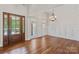 Elegant living room featuring hardwood floors, wainscoting, and a stylish chandelier at 104 Whiterock Dr, Mount Holly, NC 28120