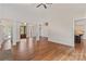Open-concept living room with hardwood floors, fireplace, and access to kitchen and entry at 104 Whiterock Dr, Mount Holly, NC 28120