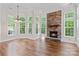 Light filled living room with many windows and stone fireplace at 104 Whiterock Dr, Mount Holly, NC 28120