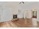Cozy living room with a stone fireplace, built-in shelving, and natural light at 104 Whiterock Dr, Mount Holly, NC 28120