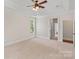 Expansive bedroom with neutral carpet, ceiling fan, and ample natural light at 104 Whiterock Dr, Mount Holly, NC 28120