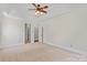 Spacious main bedroom with carpet, large windows, and access to ensuite bathroom at 104 Whiterock Dr, Mount Holly, NC 28120