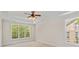 Bright main bedroom with tray ceiling and large windows that offer views of the surrounding trees at 104 Whiterock Dr, Mount Holly, NC 28120