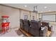 Home theater featuring tiered seating, leather recliners, projector, and vintage popcorn machine at 104 Whiterock Dr, Mount Holly, NC 28120