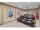 Home movie theater room, complete with a projector, leather seating, and a popcorn machine at 104 Whiterock Dr, Mount Holly, NC 28120