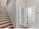 Staircase with wood steps and iron railing, adjacent to an open doorway revealing a bathroom at 104 Whiterock Dr, Mount Holly, NC 28120