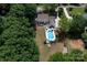 Aerial view of backyard featuring a sparkling pool, patio, outdoor seating, and lush lawn area at 105 Chippewa Trl, China Grove, NC 28023