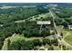 Expansive aerial shot showcasing the home's placement within a green, lush, and desirable neighborhood with golf course nearby at 105 Chippewa Trl, China Grove, NC 28023