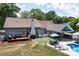 Aerial view of a backyard with a swimming pool, patio, outdoor seating, and mature trees at 105 Chippewa Trl, China Grove, NC 28023