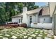 Backyard featuring a patio, stone walkway, well-maintained landscaping, and wooded surroundings at 105 Chippewa Trl, China Grove, NC 28023