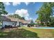 A lush, green backyard with an in-ground pool, patio area, mature trees, and a cozy deck perfect for outdoor entertaining at 105 Chippewa Trl, China Grove, NC 28023