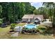 Aerial view showcasing a private backyard oasis with pool, patio, lounge chairs, and well-maintained landscaping at 105 Chippewa Trl, China Grove, NC 28023