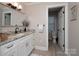 Bright bathroom featuring granite countertops, white cabinets, and updated fixtures, and access to a second bathroom at 105 Chippewa Trl, China Grove, NC 28023