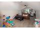 Spacious bonus room with vaulted ceilings, natural light, cozy seating, and laminate floors at 105 Chippewa Trl, China Grove, NC 28023