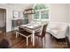Bright dining room with large window, hardwood floors, and elegant chandelier at 105 Chippewa Trl, China Grove, NC 28023
