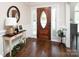 Inviting foyer with a wood front door, hardwood floors, and a decorative table at 105 Chippewa Trl, China Grove, NC 28023