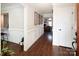 Neutral hallway with dark hardwood flooring and white wainscoting leading into living areas at 105 Chippewa Trl, China Grove, NC 28023