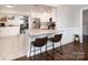Open kitchen layout with granite countertops, stainless appliances, and breakfast bar seating at 105 Chippewa Trl, China Grove, NC 28023