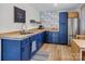Blue kitchenette featuring light wood counters, flamingo wallpaper, stainless steel refrigerator and butcher block counters at 105 Chippewa Trl, China Grove, NC 28023