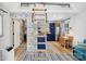 Lofted living space with whimsical wallpaper, wooden ladder to bed, and kitchenette with stainless steel refrigerator at 105 Chippewa Trl, China Grove, NC 28023
