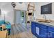 Compact living space with sliding glass doors to a patio, a loft ladder and blue kitchenette at 105 Chippewa Trl, China Grove, NC 28023