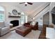 Comfortable living room showcasing a fireplace, staircase, and hardwood floors at 105 Chippewa Trl, China Grove, NC 28023