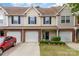Charming townhouse with tan siding, blue shutters, and a one-car garage in a well-maintained neighborhood at 10617 Fuller Ridge Cir, Charlotte, NC 28270