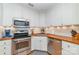Cozy kitchen featuring stainless steel appliances, white cabinets, and butcher block countertops at 10617 Fuller Ridge Cir, Charlotte, NC 28270