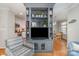 Living room featuring a built-in media center, offering seamless flow into the kitchen and dining area at 10617 Fuller Ridge Cir, Charlotte, NC 28270