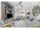 Well-lit living room showcasing stylish decor, comfortable seating, and a ceiling fan at 10617 Fuller Ridge Cir, Charlotte, NC 28270