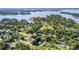 Expansive aerial view of waterfront community featuring lush greenery, lake access, and a marina at 113 Marina Ln, Mooresville, NC 28117