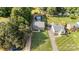 An aerial view showcases a home with a long driveway, lush greenery, and a detached garage at 113 Marina Ln, Mooresville, NC 28117