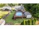 An aerial view captures a backyard with a swimming pool, wooden deck, detached garage, and lush landscaping at 113 Marina Ln, Mooresville, NC 28117