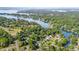 Picturesque aerial view of homes nestled along the tree-lined shore of a serene lake at 113 Marina Ln, Mooresville, NC 28117
