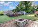 A spacious backyard offers a wooden deck with a fire pit and landscaped areas for outdoor living at 113 Marina Ln, Mooresville, NC 28117