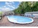 Inviting backyard featuring an in-ground pool with a spacious wooden deck and lush greenery at 113 Marina Ln, Mooresville, NC 28117