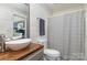 Charming bathroom with shiplap walls, modern fixtures, and a decorative shower curtain at 113 Marina Ln, Mooresville, NC 28117
