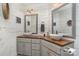 Bright bathroom featuring double sinks, modern fixtures, and white shiplap walls at 113 Marina Ln, Mooresville, NC 28117