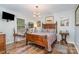 Cozy bedroom featuring wood-look floors, stylish decor, and ample natural light at 113 Marina Ln, Mooresville, NC 28117