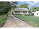 Attractive home showcasing a well-manicured lawn, gravel driveway and charming front porch at 113 Marina Ln, Mooresville, NC 28117
