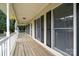 Spacious front porch with wood flooring, complemented by black shutters and decorative hanging baskets at 113 Marina Ln, Mooresville, NC 28117