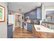 Open kitchen features blue cabinets, butcher block counters, and stainless appliances at 113 Marina Ln, Mooresville, NC 28117