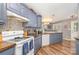 Open kitchen features blue cabinets, butcher block counters, and stainless appliances at 113 Marina Ln, Mooresville, NC 28117